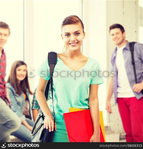 student girl with school bag and folders at school