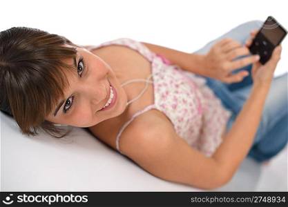 Student - Happy female teenager listen to music with ear buds, holding mp3 player
