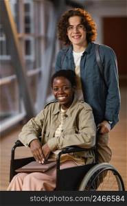 student helping colleague wheelchair