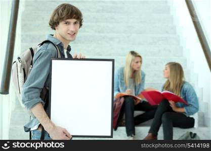 Student holding blank poster