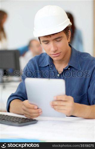 Student in architecture using electronic tablet
