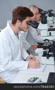 student in biology using microscope in training class