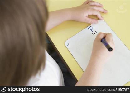 Student in class learning numbers (selective focus)