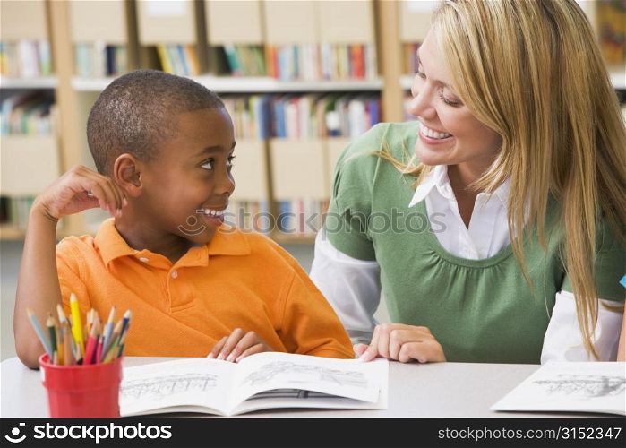 Student in class reading with teacher