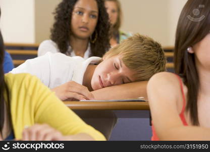 Student in class sleeping (selective focus)