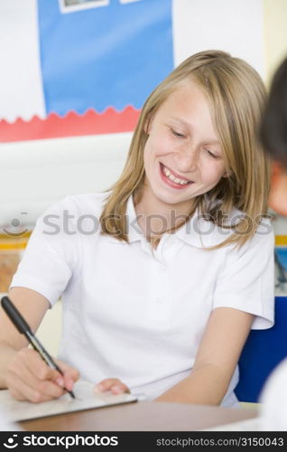 Student in class taking notes