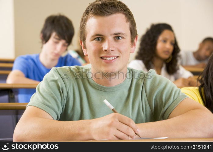 Student in class taking notes (selective focus)