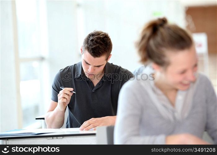 Student in class writing assignment