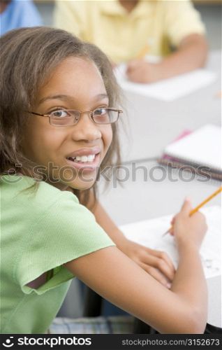 Student in class writing (selective focus)