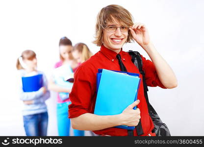 Student in red shirt wearing glasses and with books