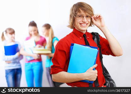 Student in red shirt wearing glasses and with books