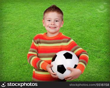 Student little child with soccer ball with green grass background