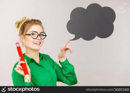 Student looking woman wearing nerdy eyeglasses holding big oversized pencil thinking about something, black speech bubble next to her. Woman holding big oversized pencil thinking