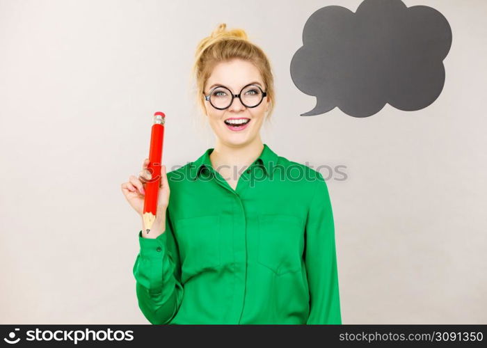 Student looking woman wearing nerdy eyeglasses holding big oversized pencil thinking about something, black speech bubble next to her. Woman holding big oversized pencil thinking