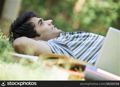 Student lying down in a park