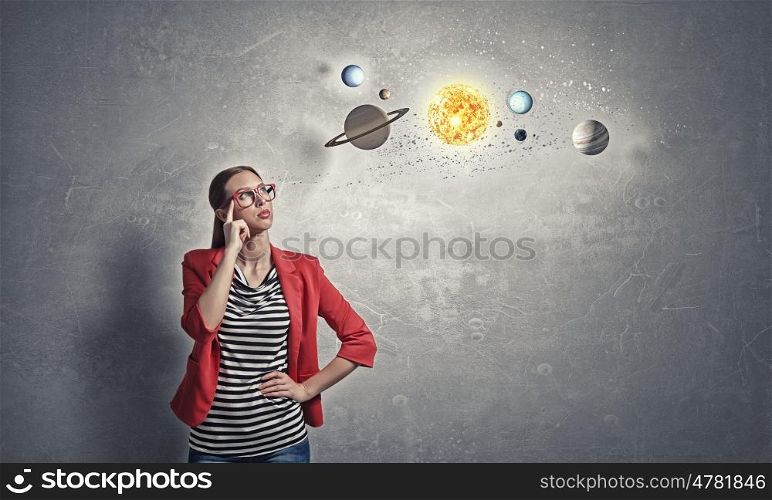Student of astronomy faculty. Young woman student in red jacket and glasses thinking about space