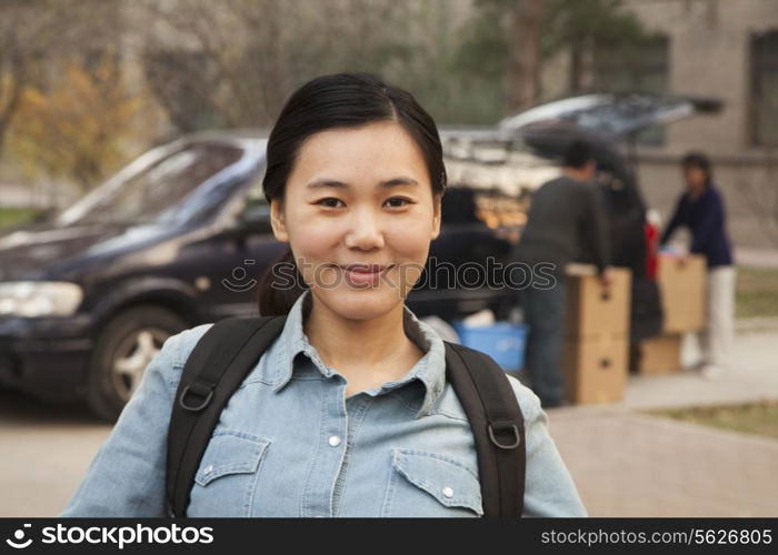Student portrait in front of dormitory at college