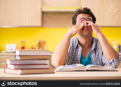 Student preparing for exam sitting at the kitchen 