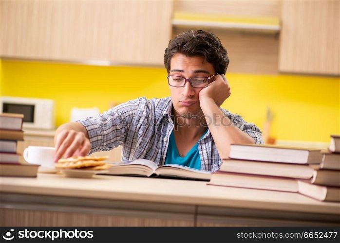 Student preparing for exam sitting at the kitchen 