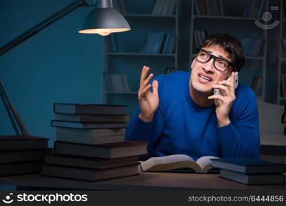 Student preparing for exams late at night in library