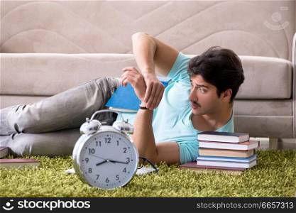 Student preparing for university exams at home in time management concept. Student preparing for university exams at home in time managemen