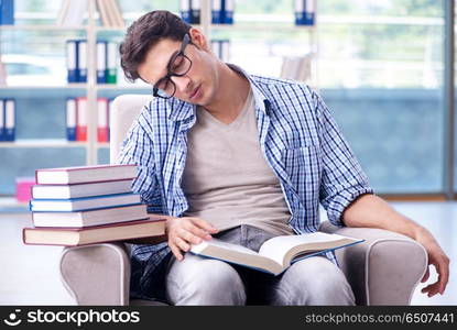 Student reading books and preparing for exams in library