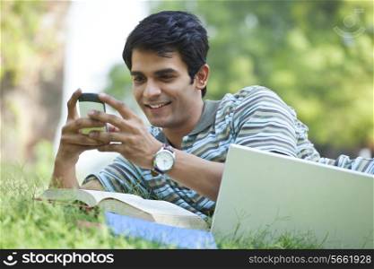 Student sending a text message on mobile phone