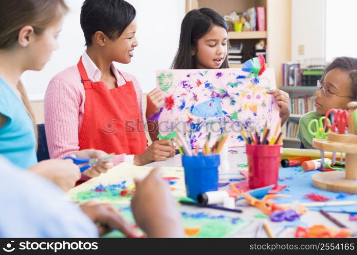 Student showing teacher and classmates her artwork (selective focus)