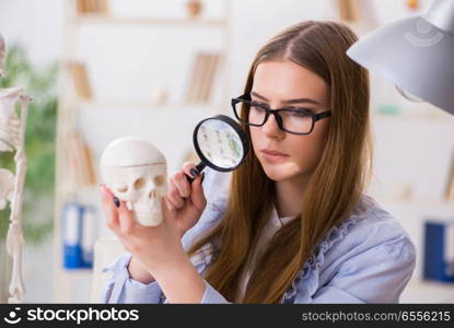 Student sitting in classroom and studying skeleton