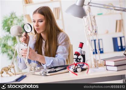 Student sitting in classroom and studying skeleton
