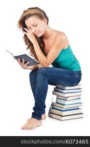 Student sitting on stack of books