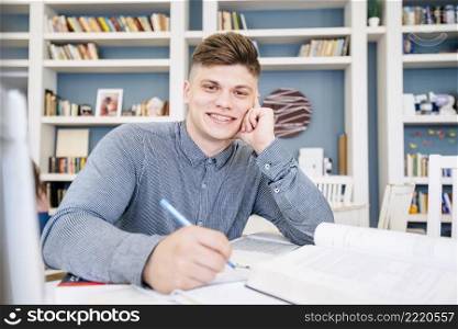 student sitting with books pen library