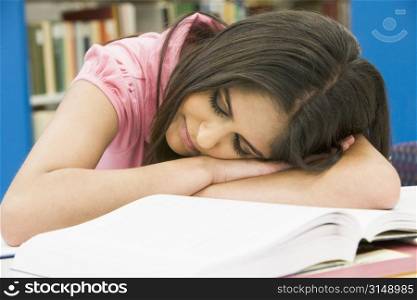 student sleeping in library