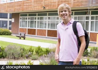Student standing outdoors smiling