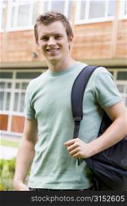Student standing outdoors smiling