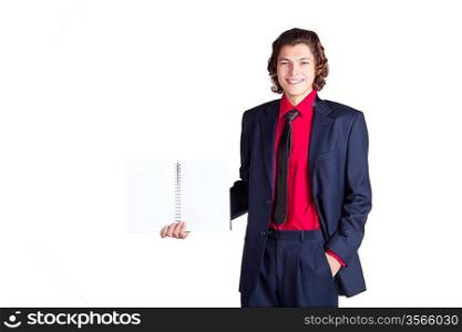 student stands with notebook in gray suit and red shirt on white background