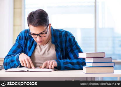 Student studying in the empty library with book preparing for exam. Student studying in the empty library with book preparing for ex