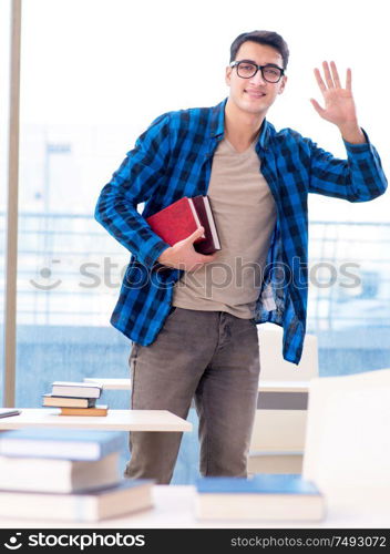 Student studying in the empty library with book preparing for exam. Student studying in the empty library with book preparing for ex