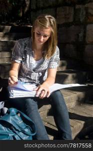 student studying on stone steps