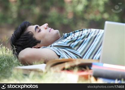 Student taking a nap in a park