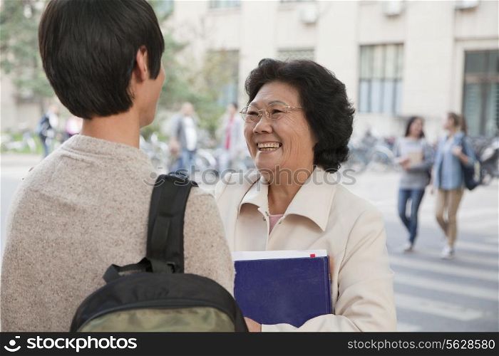 Student talking with his professor