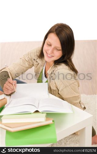 Student teenager happy girl write homework with book