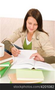 Student teenager happy girl write homework with book