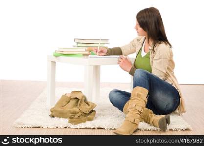 Student teenager happy girl write homework with books