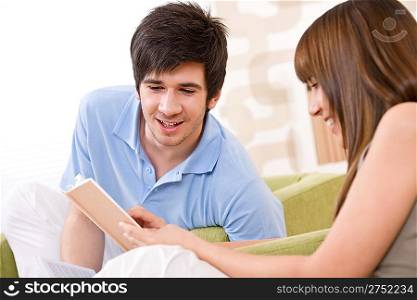Student - two teenager reading book in lounge, sitting on armchair