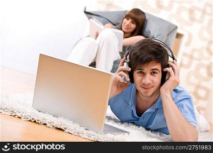 Student - Two teenager with laptop and headphones, woman reading book relaxing