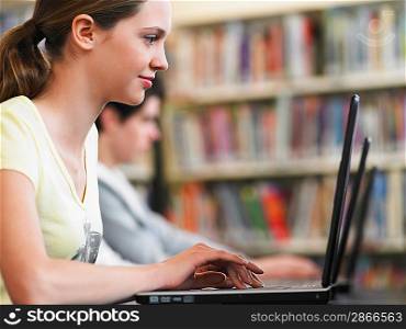 Student Using Laptop in Library