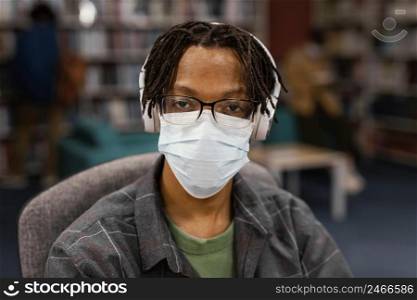 student wearing face masks library 2