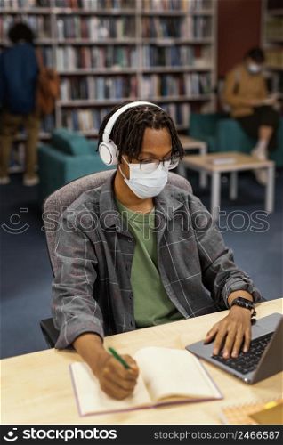 student wearing face masks library 3