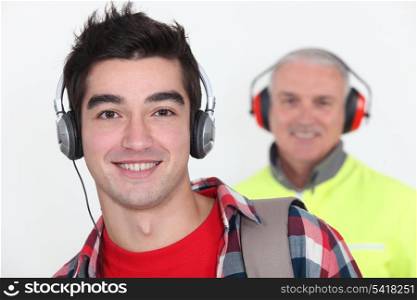 Student wearing headphones near builder